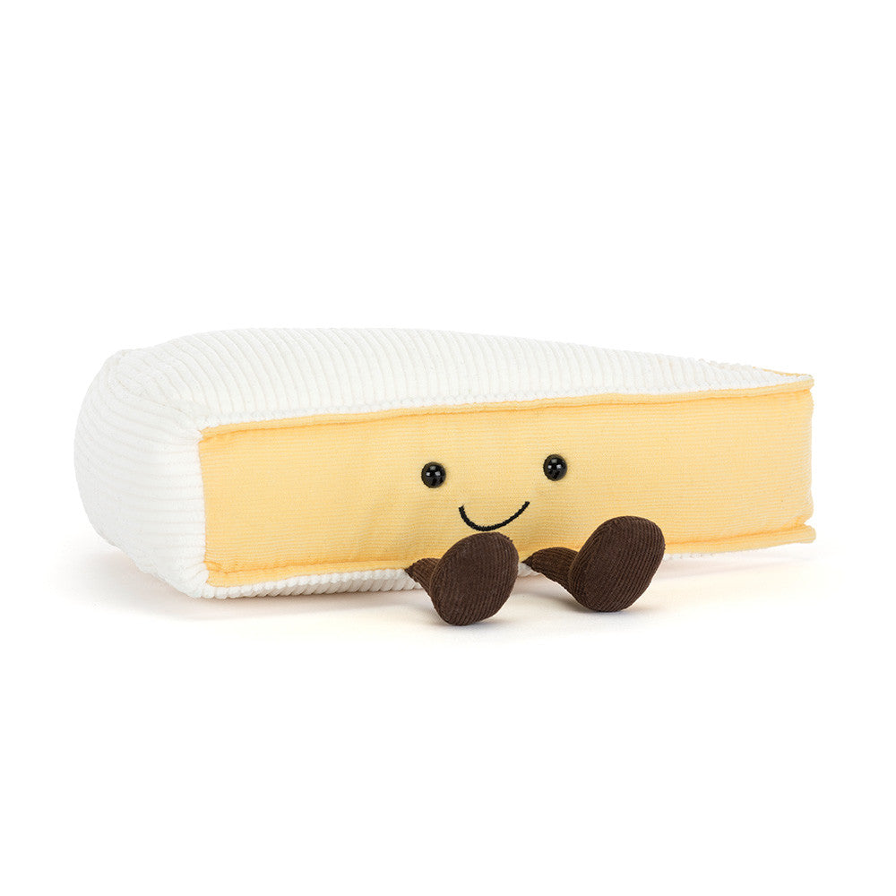 Plush toy resembling a banana with a smiling face on a white background