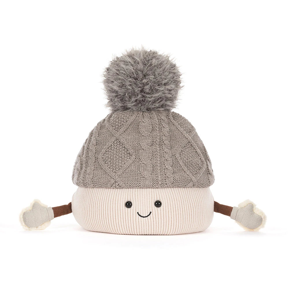 A cute, smiling knit pom-pom hat with a gray cable-knit top section, a cream-colored bottom section, and small brown arms ending in cream mittens, shown on a solid white background.