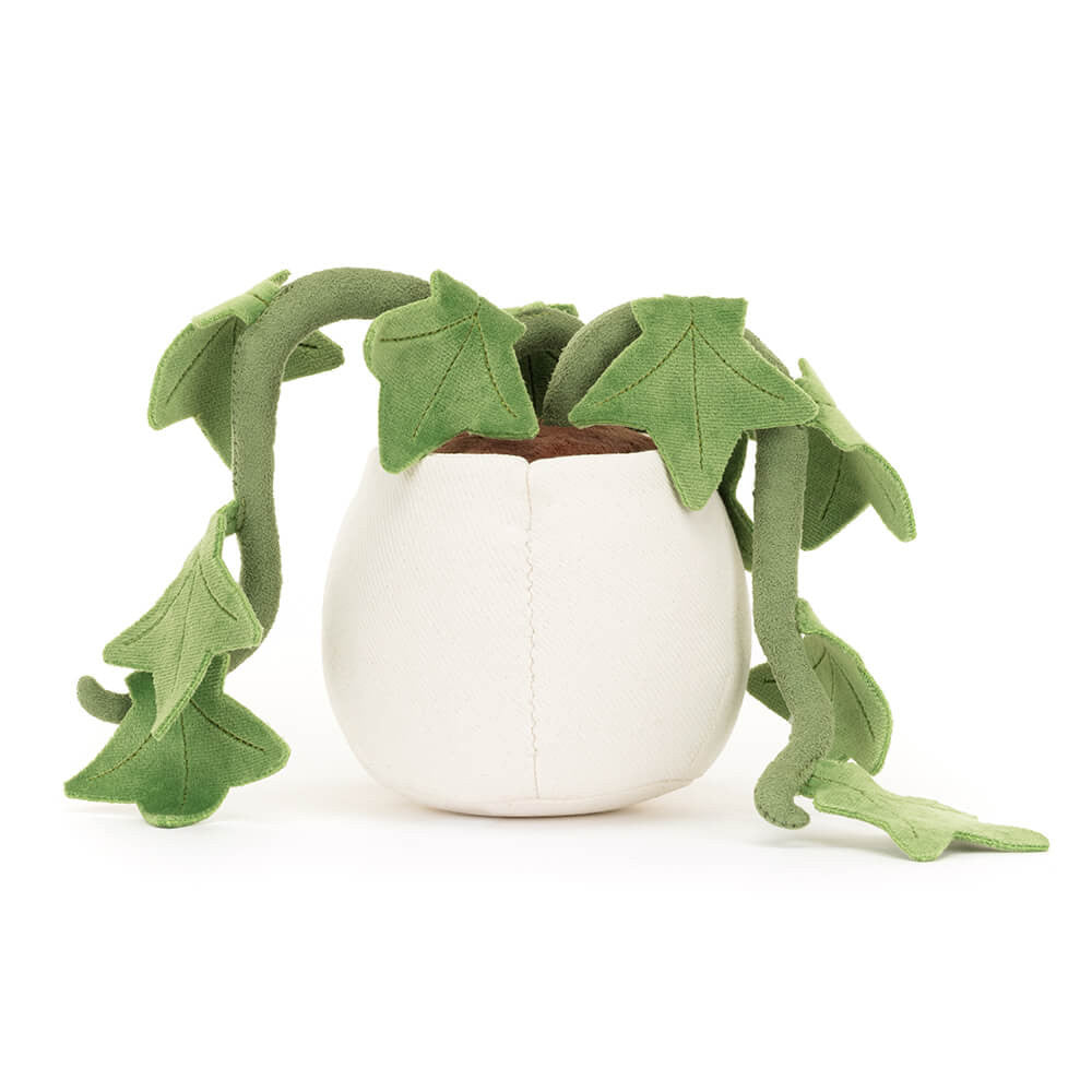 Plush toy resembling a potted plant with green leaves on a white background