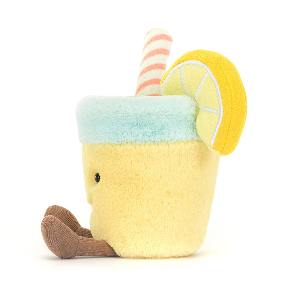 A plush toy resembling a glass of lemonade with a lemon slice and a straw, smiling face at the bottom.
