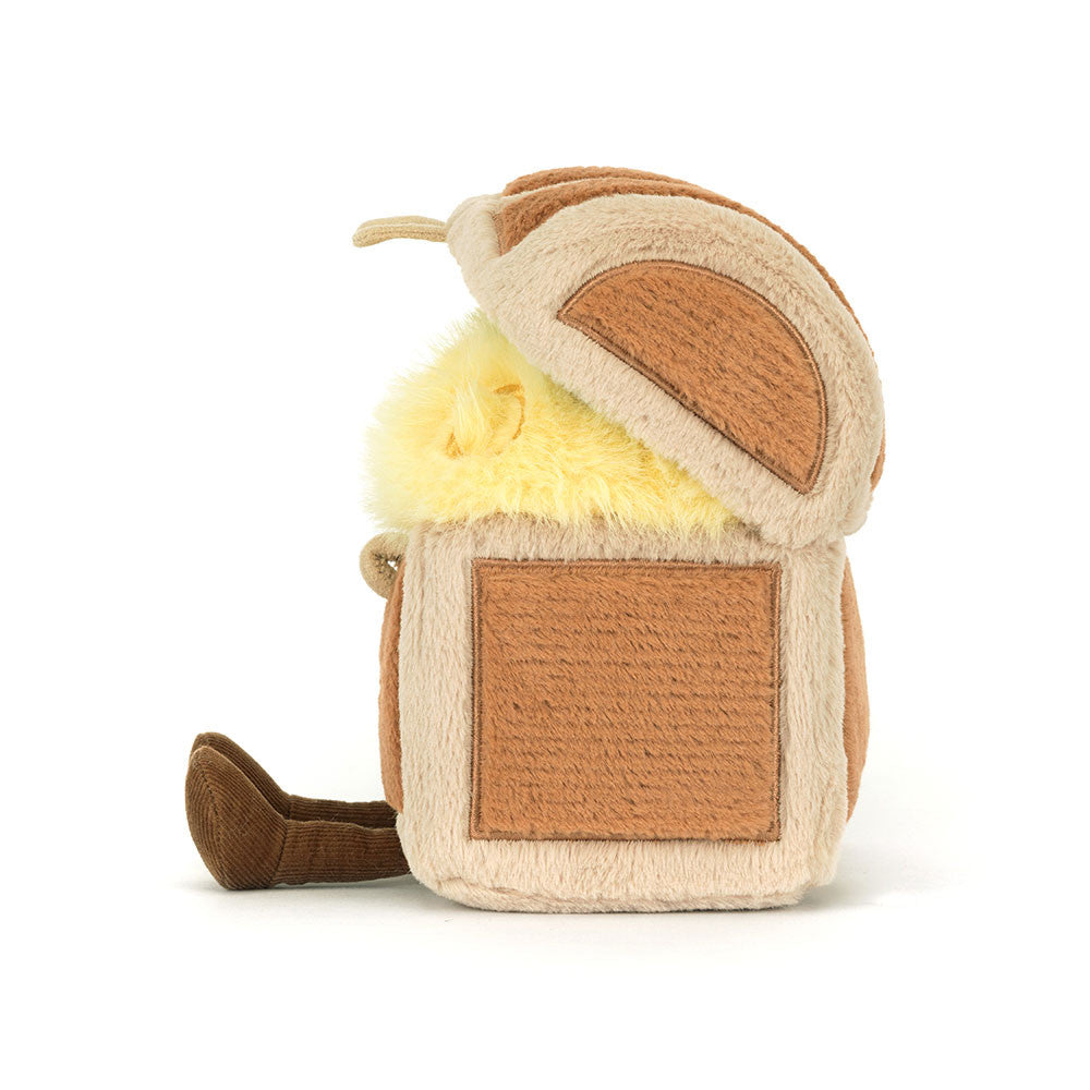 Cube-shaped plush toy with brown and beige pattern on a white background