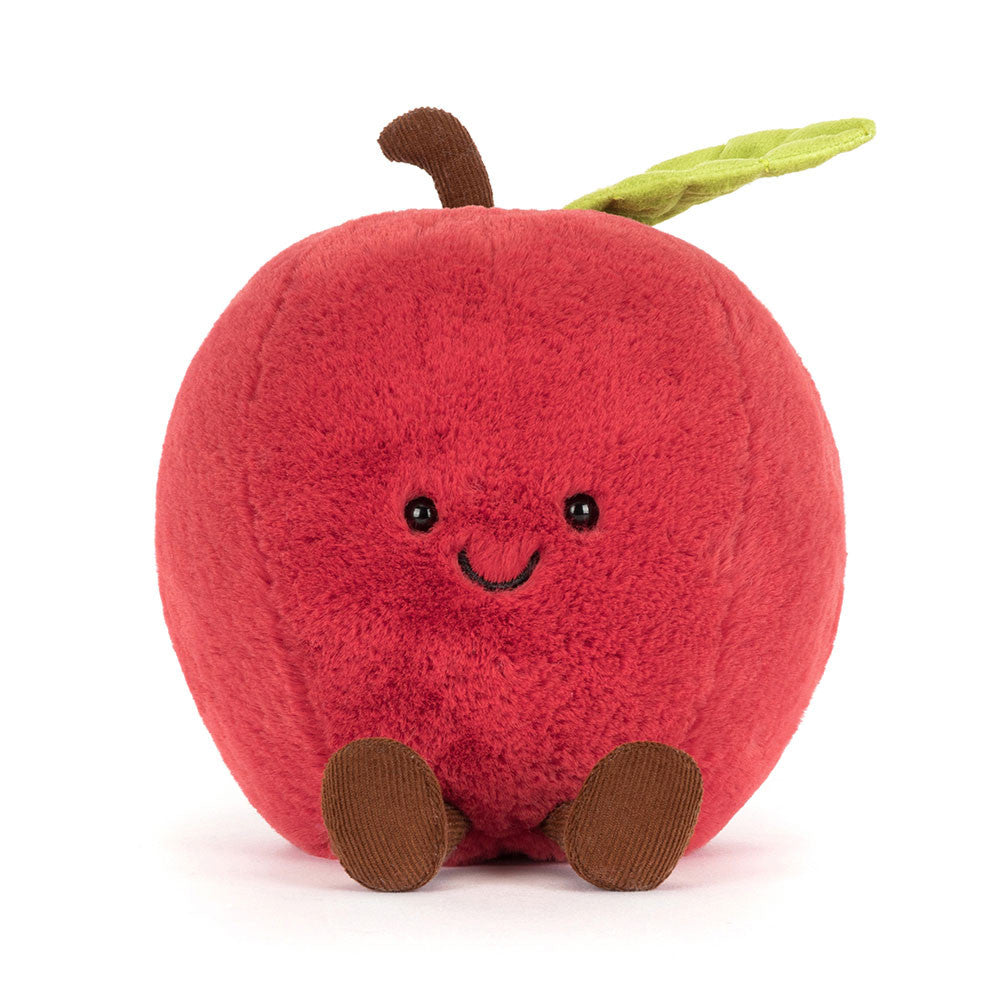 Plush toy shaped like a red apple with a smiling face on a white background