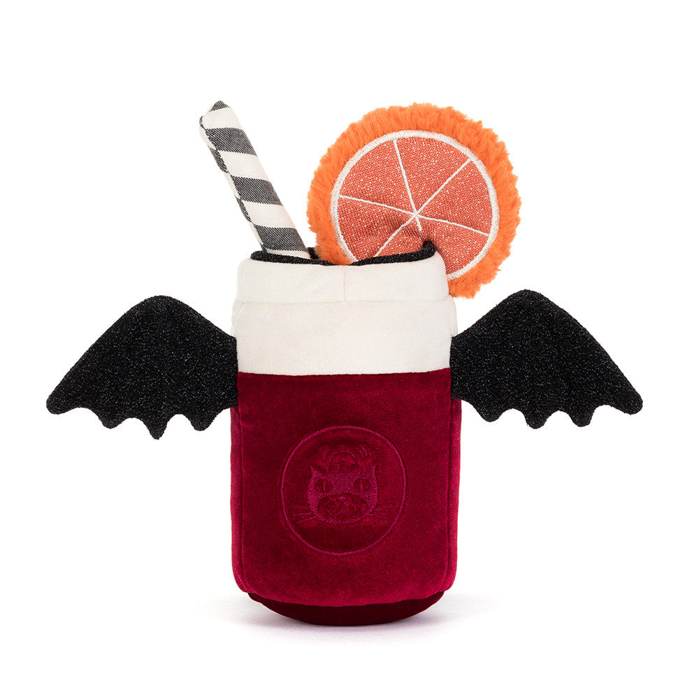 A plush vampire cocktail cup toy on a white background, featuring a deep red body with a bat emblem, black wings, a white foam top, a black-and-white striped straw, and an orange slice garnish.