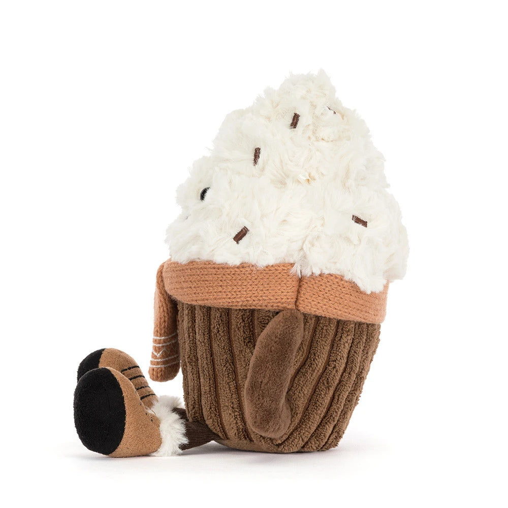 A plush cupcake toy with fluffy white faux-cream frosting, brown knit wrapper, and a small brown boot attached to the side, photographed on a clean white background.