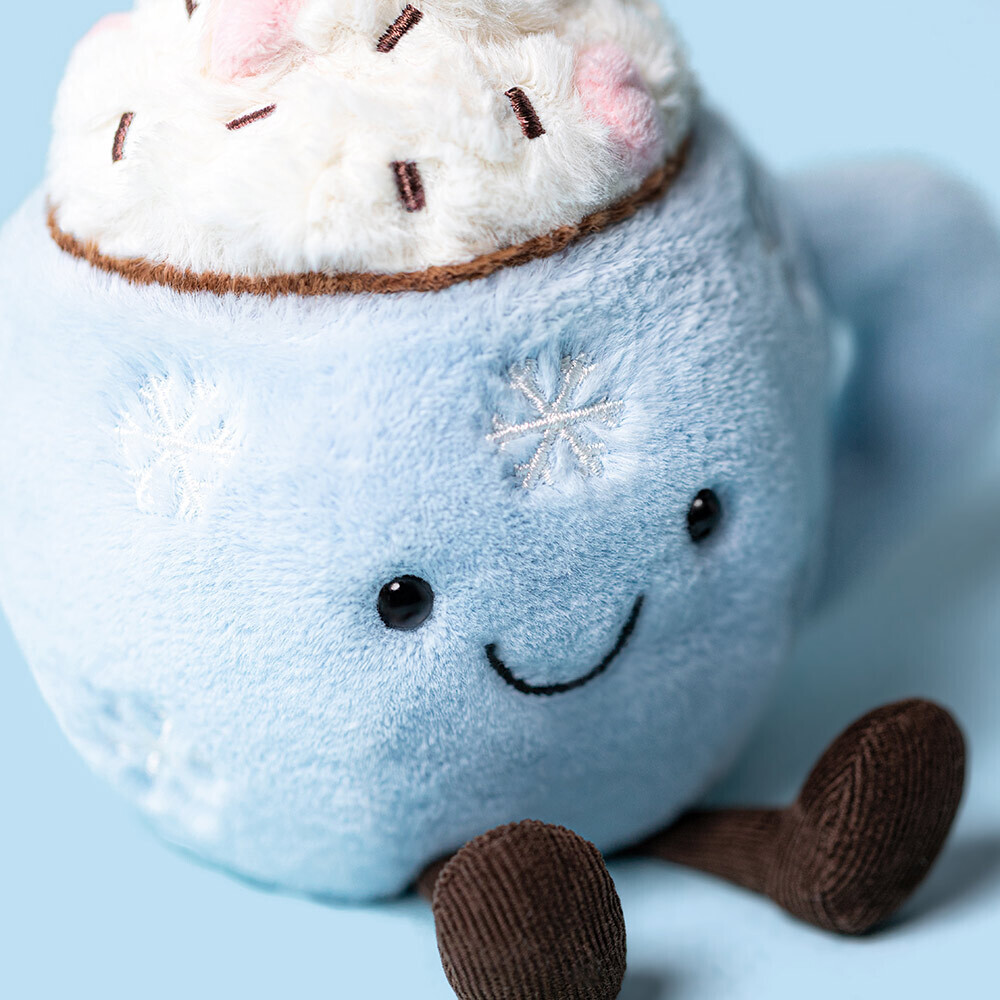 Plush toy resembling a hot chocolate mug with marshmallows on a light blue background