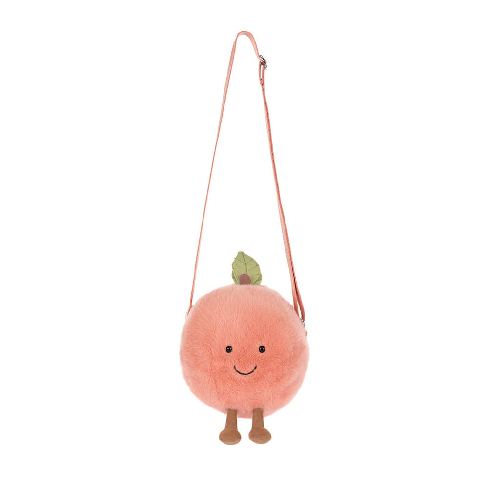 Plush peach-shaped bag with a strap on a white background