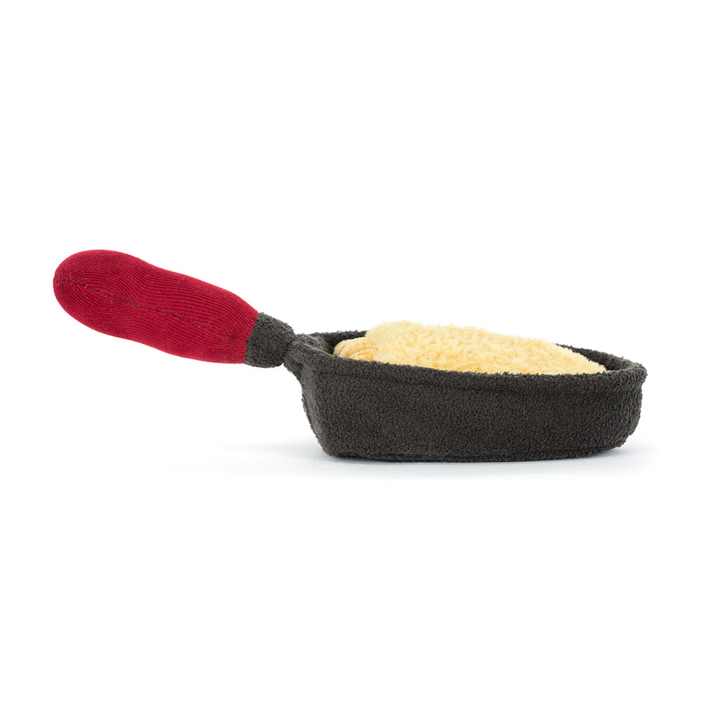 Toy resembling a miniature frying pan with a red handle on a white background