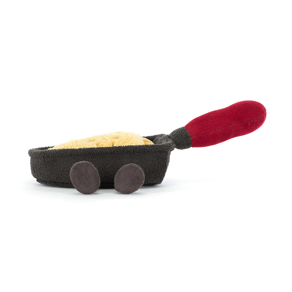 Toy resembling a frying pan with a red handle on a white background