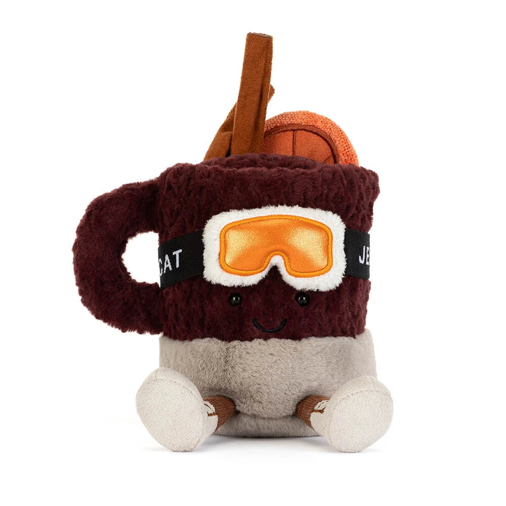 A plush coffee mug character toy with a dark brown fuzzy body, orange ski goggles, a smiling face, and small brown and cream feet, shown on a plain white background.