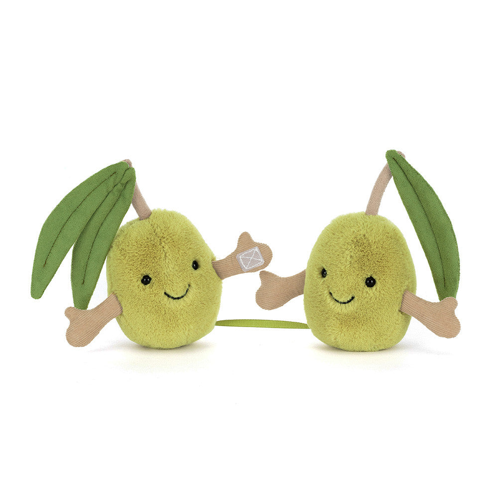 Two plush mango toys with leafy stems on a white background