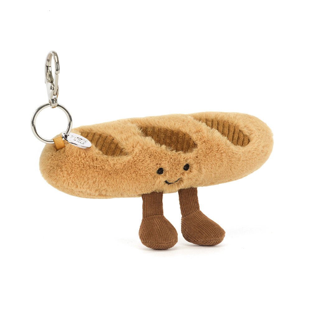 Plush sandal keychain with a smiling face on a white background