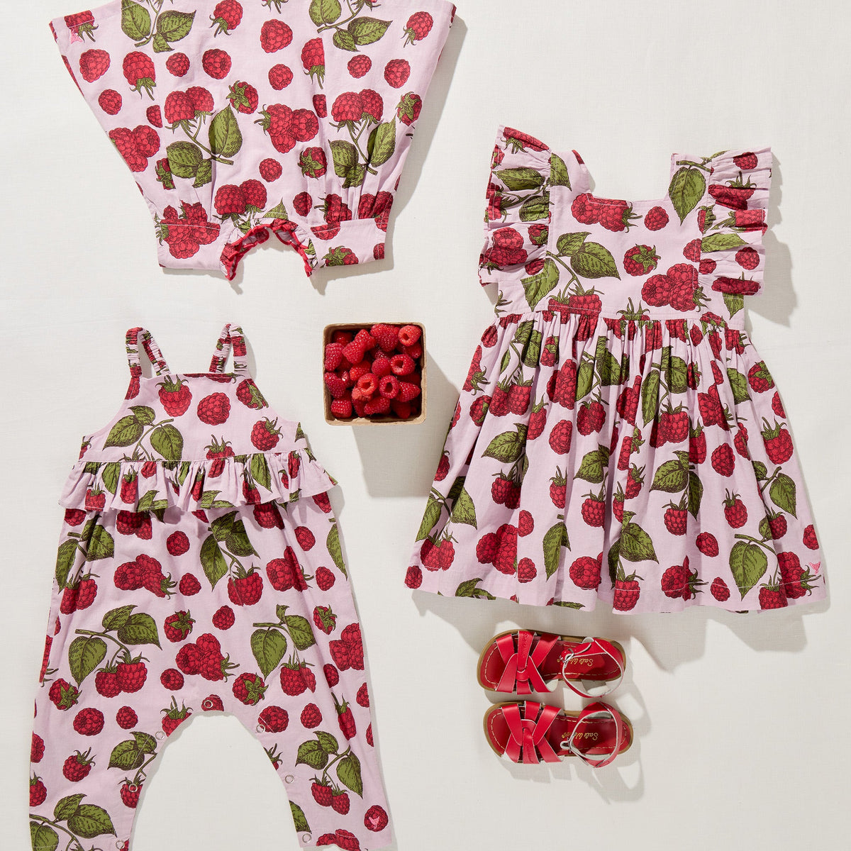 Children's clothing set with raspberry pattern on a white background