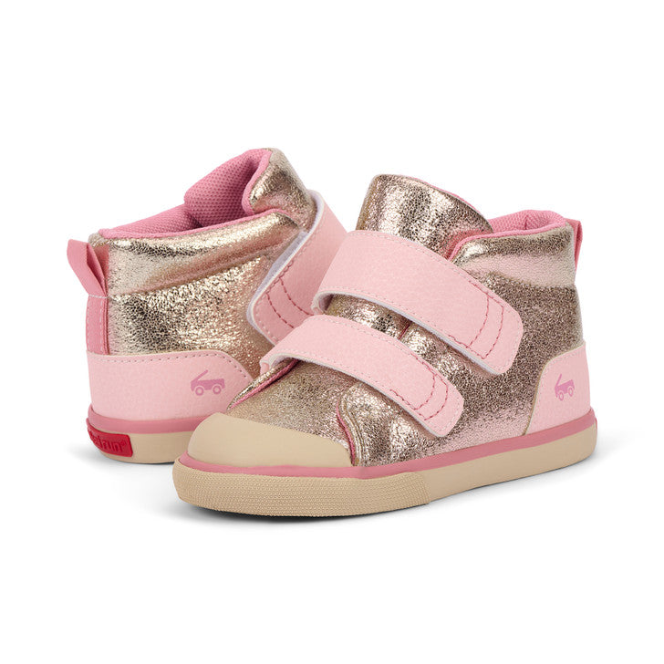 Pair of pink and gold children's shoes on a white background
