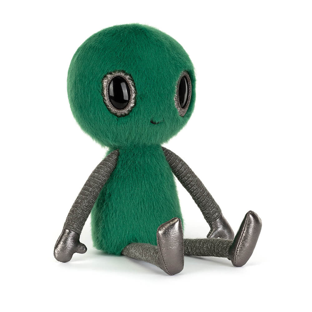 A green alien plush toy with large black eyes outlined in silver, a small stitched smile, and textured silver arms and legs, sitting against a plain white background.