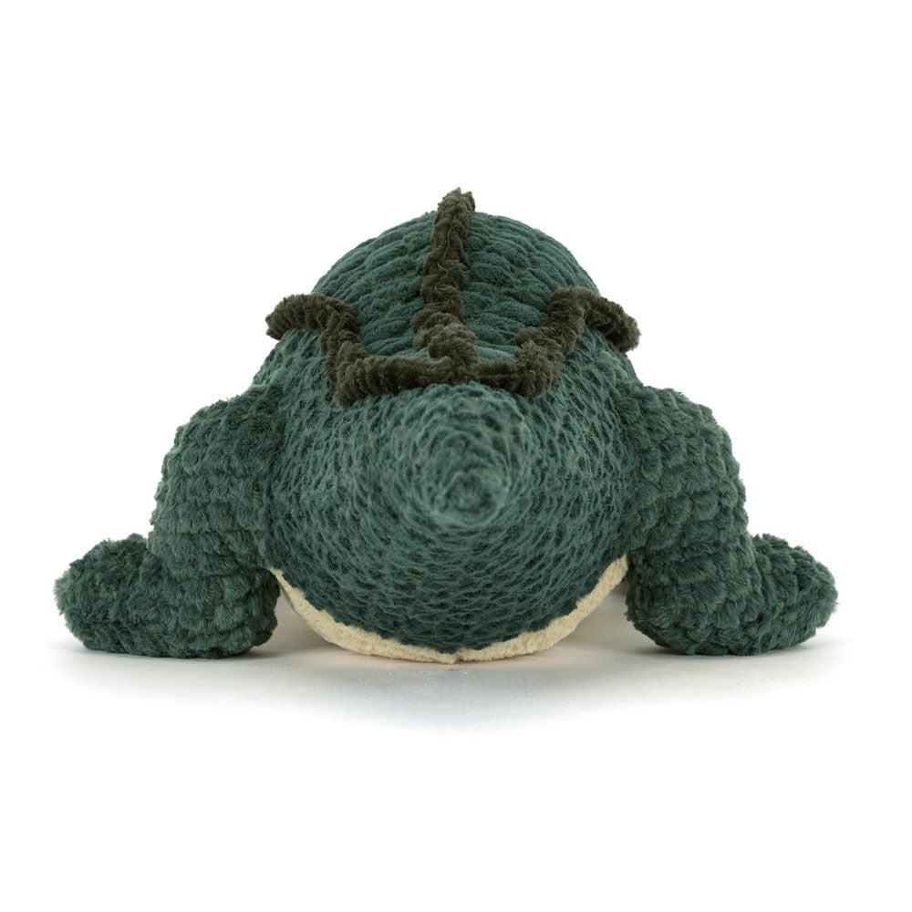 Green knitted dinosaur toy on a white background