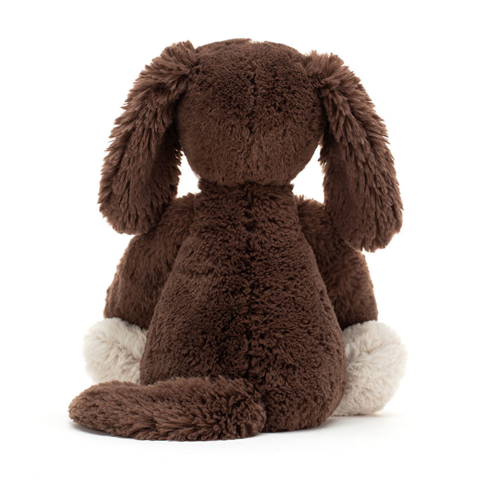 Brown plush dog toy on a white background