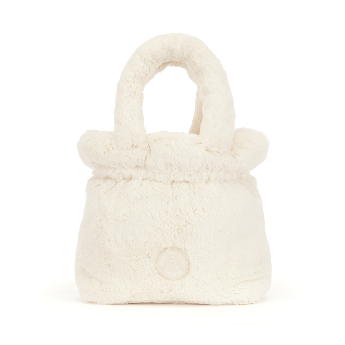 A small plush faux-fur handbag in a warm off-white or cream color, featuring a rounded top handle and a circular button detail on the front, set against a plain white background.
