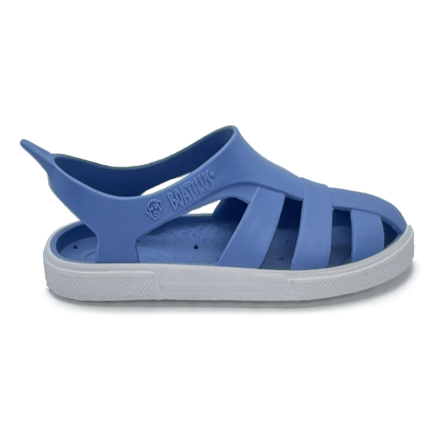 Blue sandal with a white sole on a white background