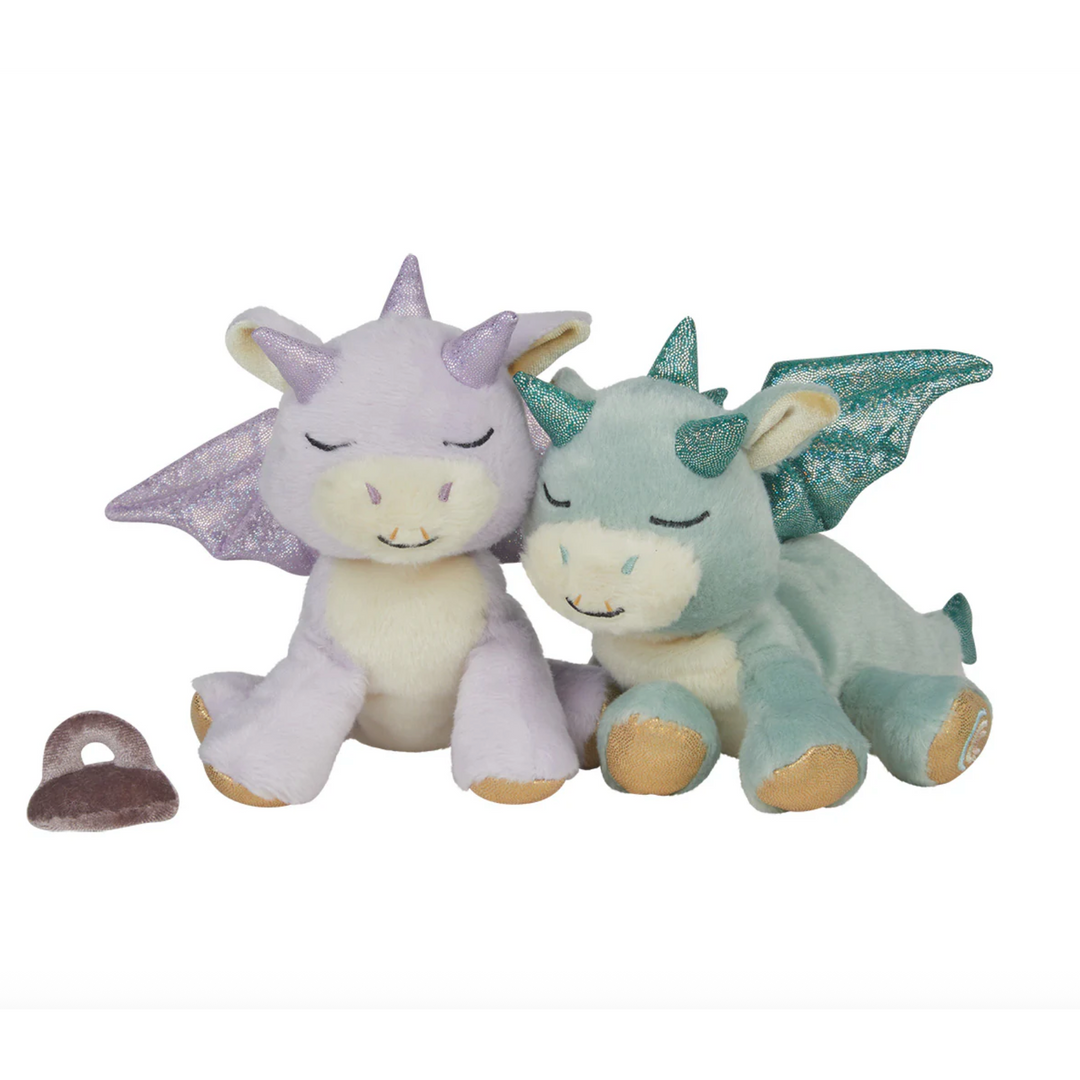 Two plush dragon toys, one purple and one green, sitting next to each other on a white background.
