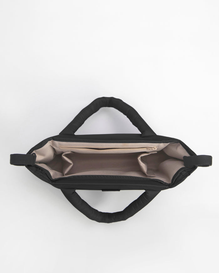 Black bag with beige interior on a white background