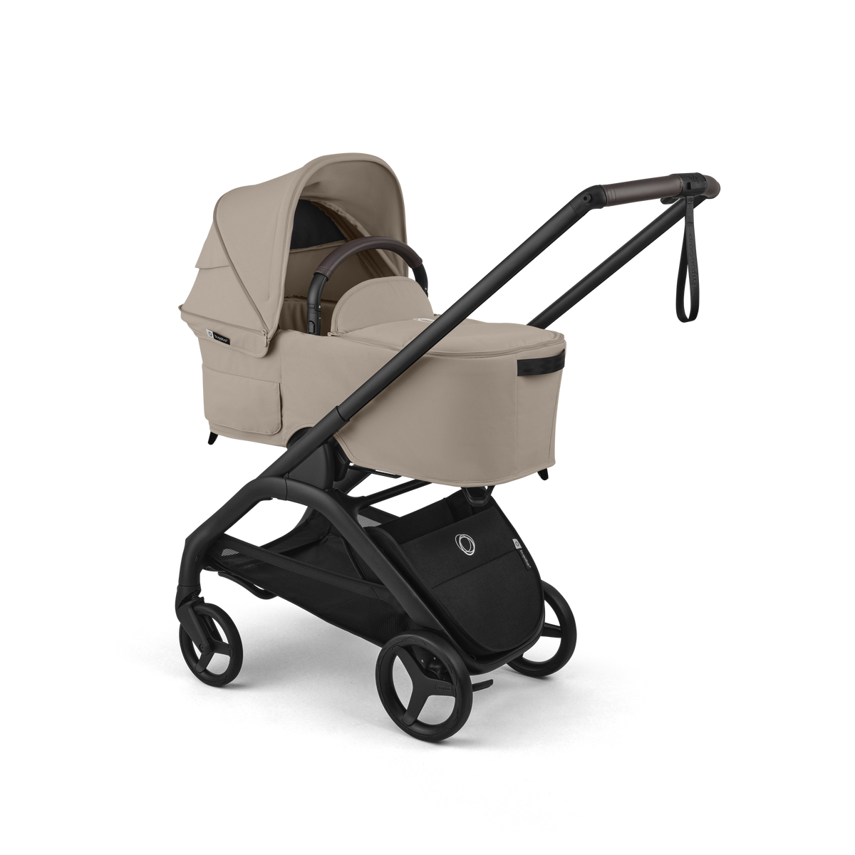 A luxury stroller travel system in beige and black, featuring a padded bassinet, matching canopy, and a sleek black stroller frame with four wheels, shown on a pure white background.