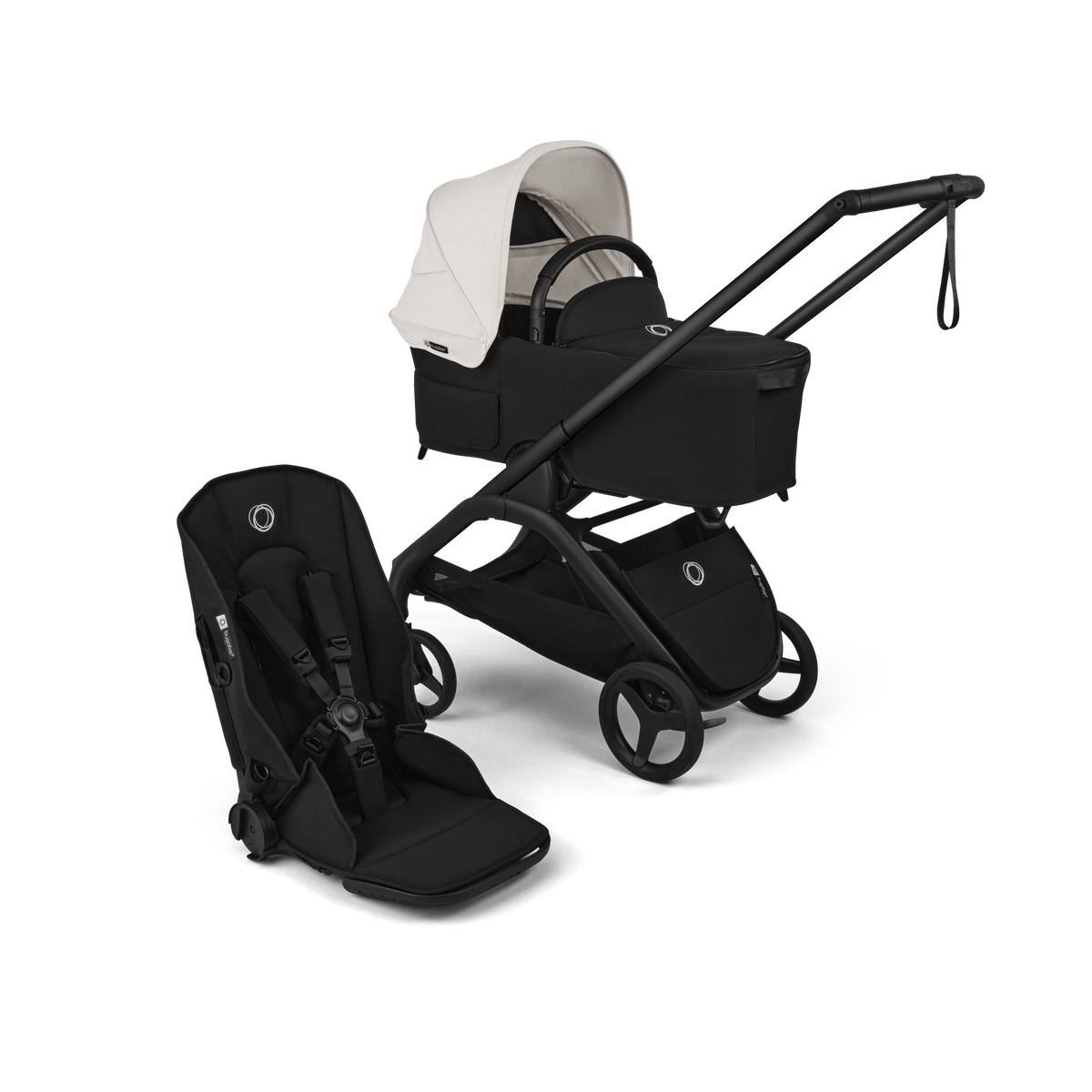 A stroller travel system set against a solid black background, featuring a black stroller with a white canopy, a matching black bassinet seat, and a black infant car seat.