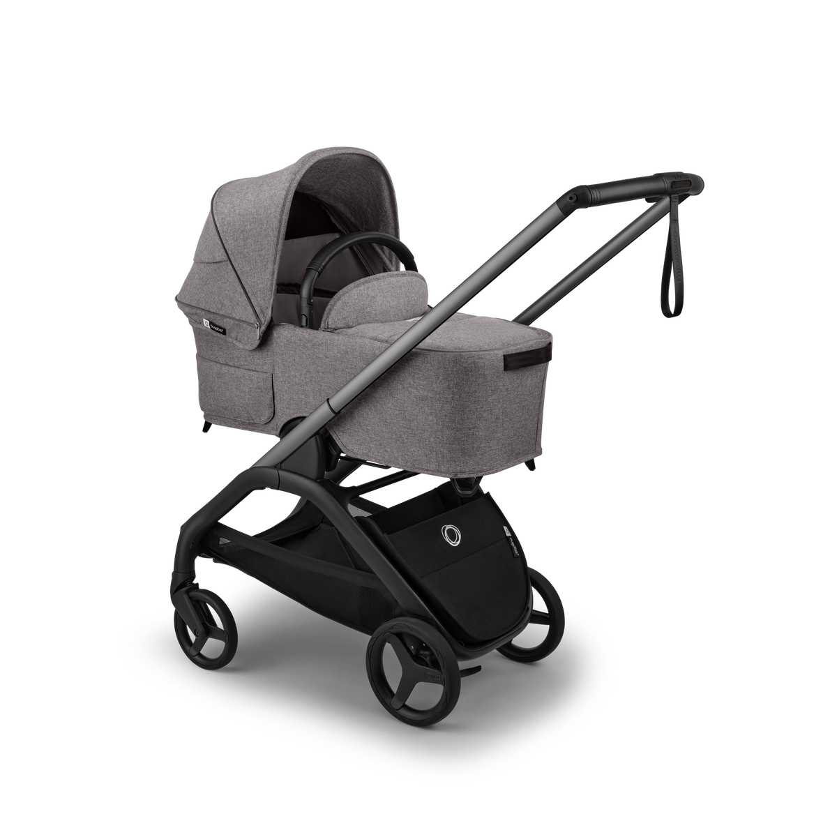 A stroller bassinet attachment in heather gray fabric mounted on a black stroller frame, shown at a three-quarter angle on a clean white background.
