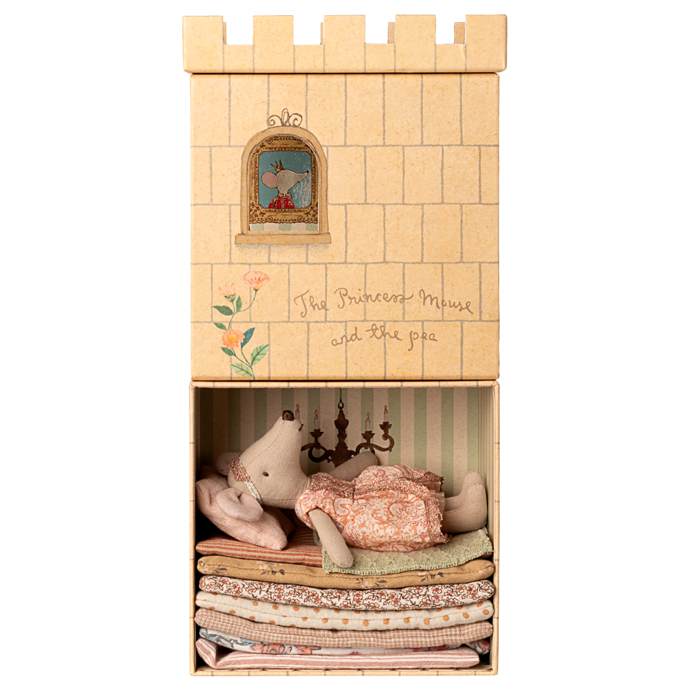 A Maileg toy set featuring an illustrated castle box with a lower compartment that opens to reveal a Big Sister mouse resting atop a tall stack of colorful layered mattresses.