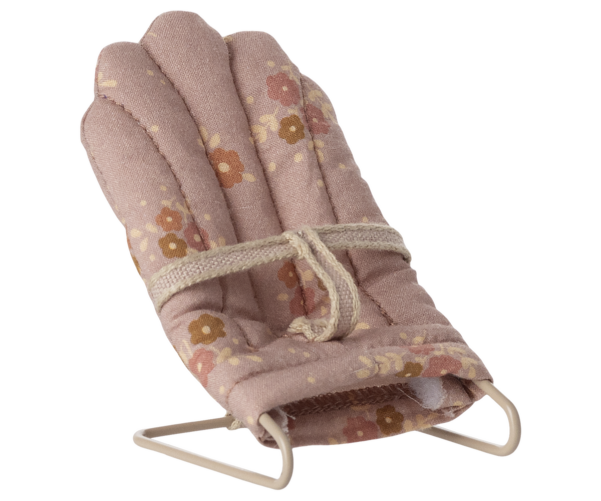 Baby bouncer with floral pattern on a white background