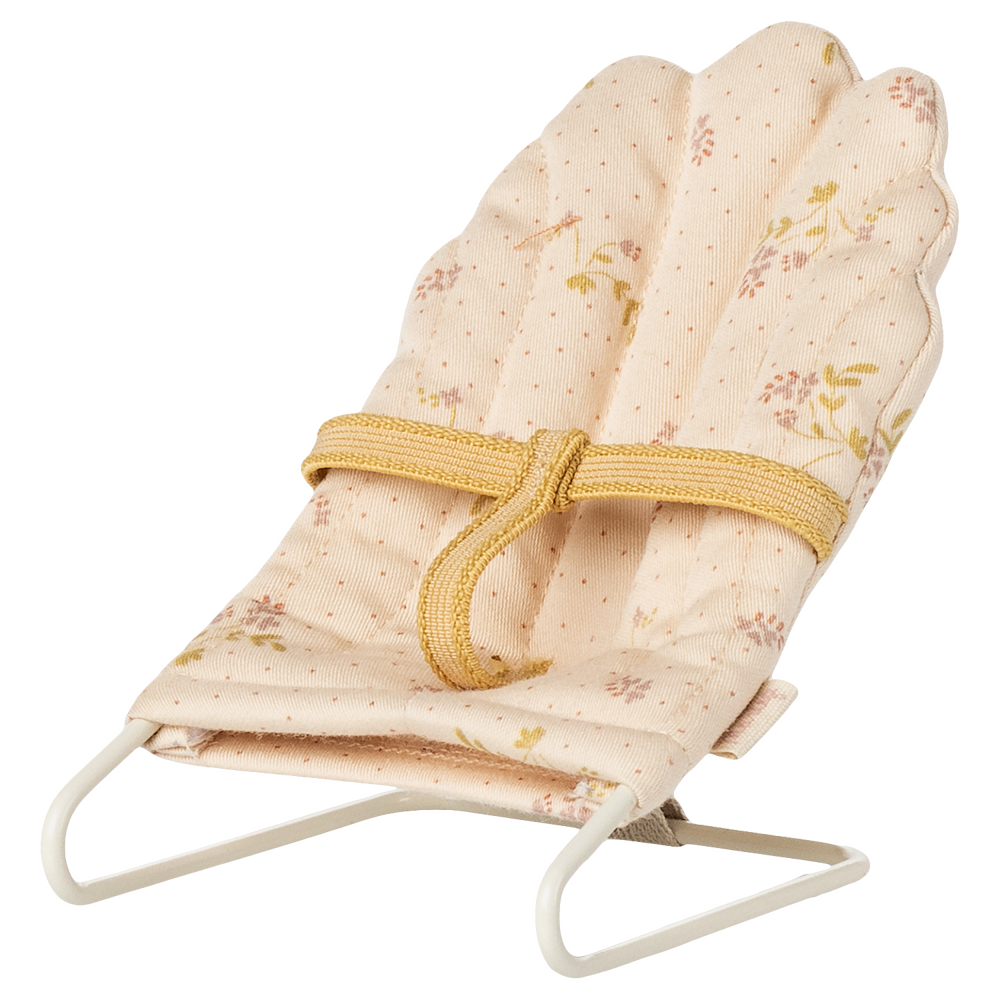 A miniature off-white Maileg micro babysitter bouncy chair with a soft floral patterned fabric seat and a metal wire frame, shown against a transparent checkered background.