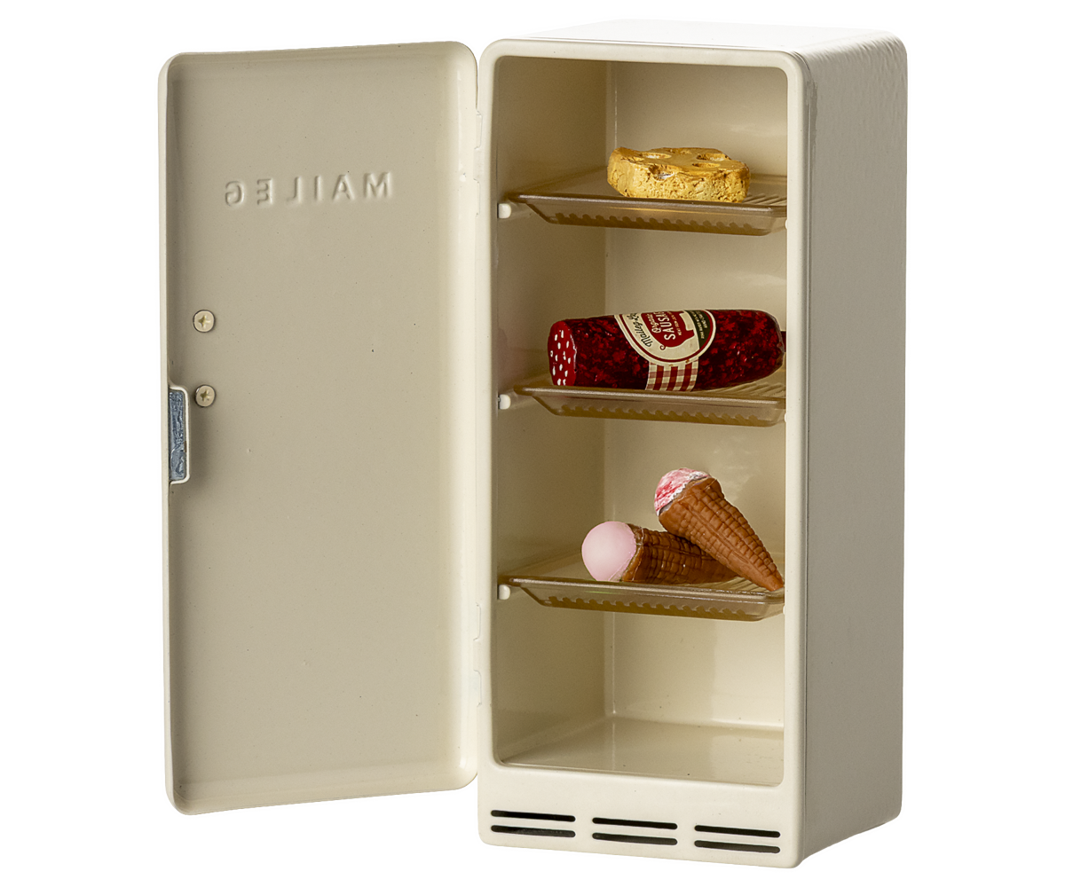 Small beige refrigerator with ice cream cones and a bottle inside on a white background
