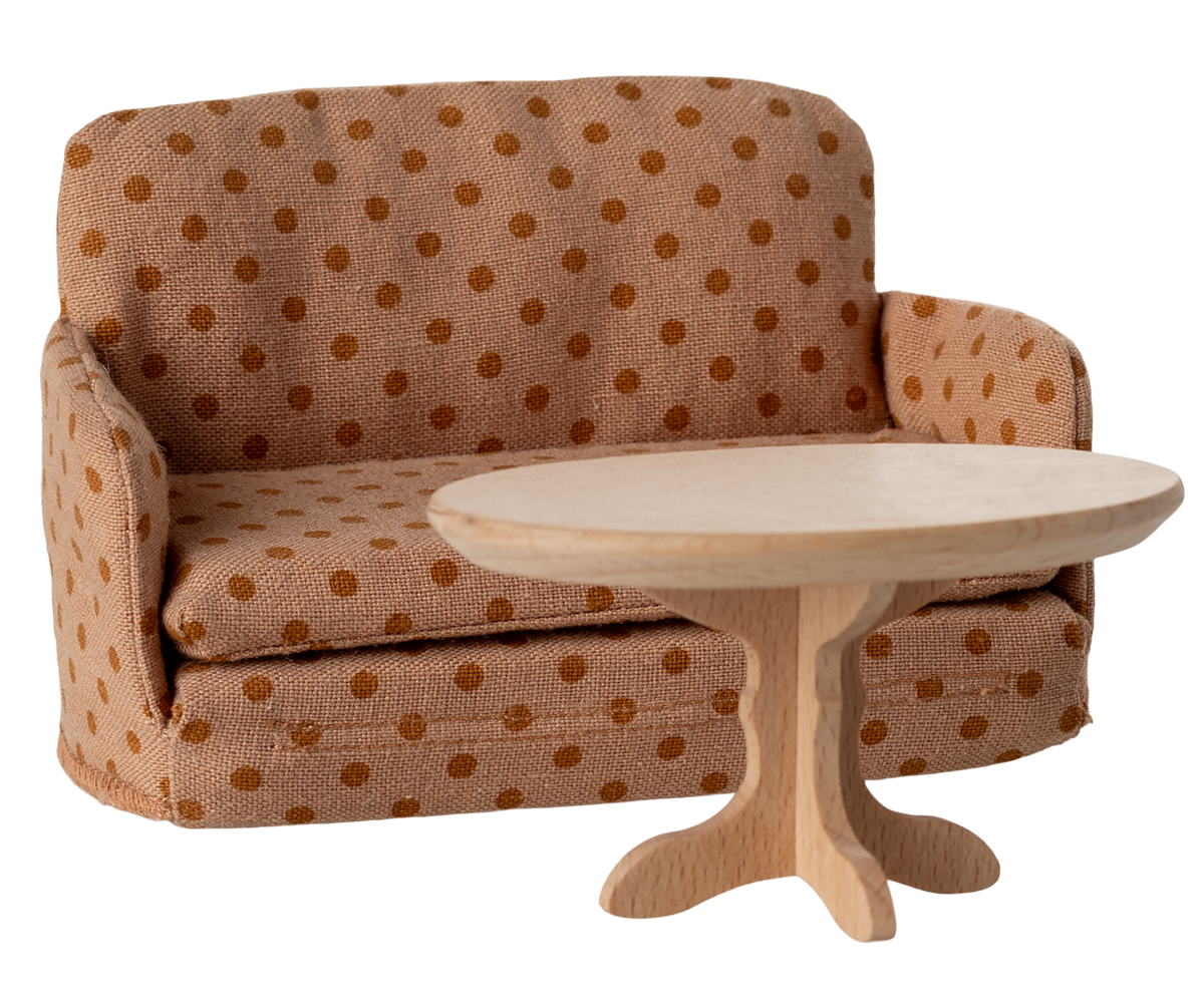 Polka dot sofa with a matching side table on a white background