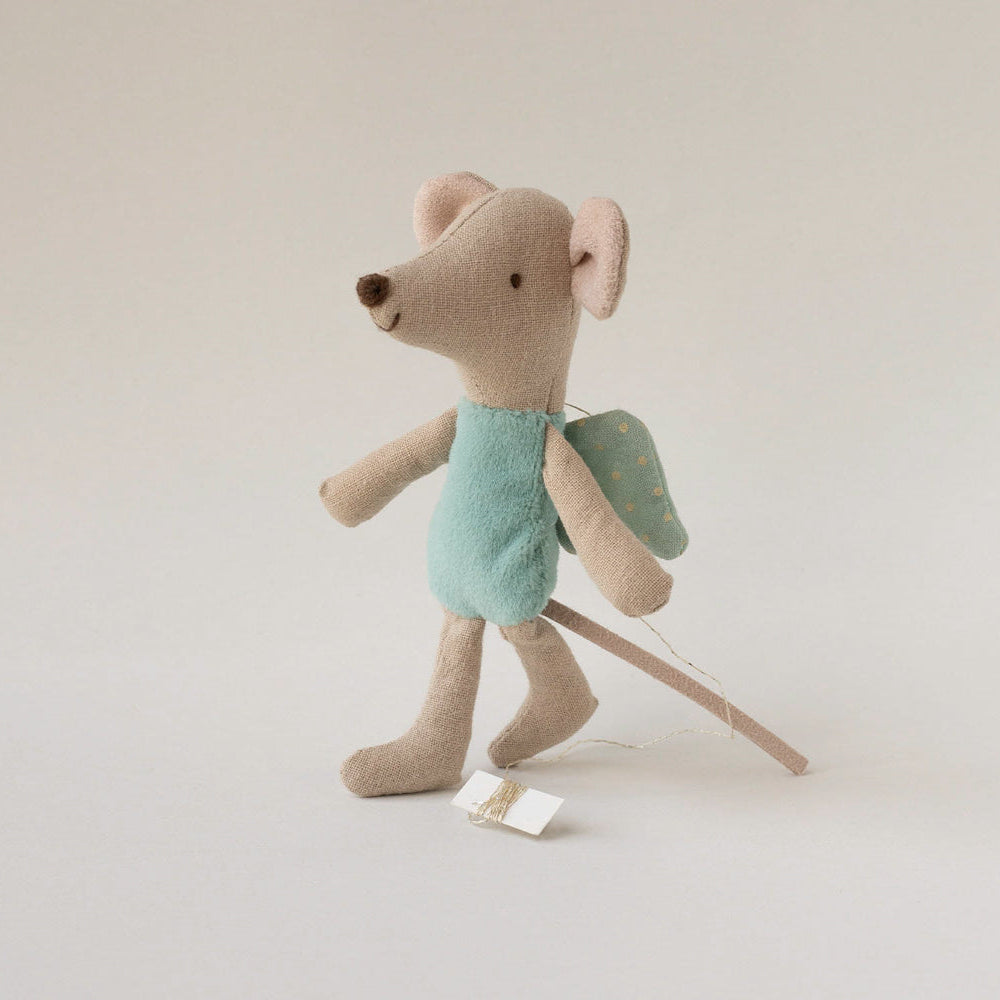 Stuffed toy mouse with a backpack on a plain background
