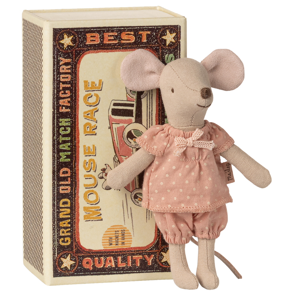 Stuffed mouse toy in a pink outfit standing next to a matchbox with decorative text.