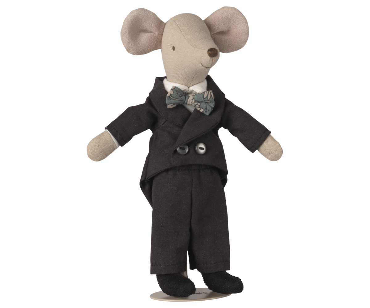Stuffed toy mouse in a black suit with a bow tie on a white background