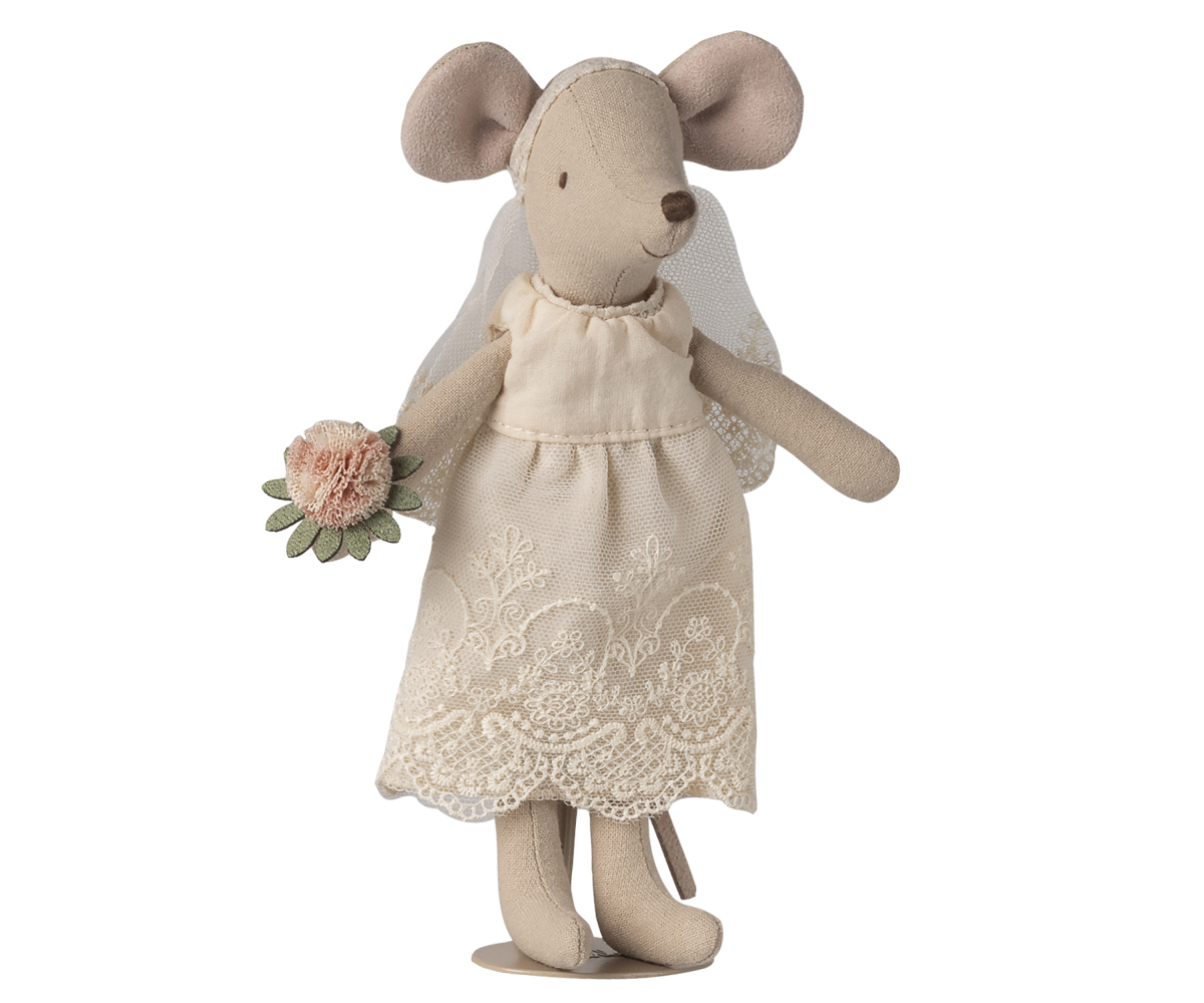 Stuffed mouse toy in a lace dress holding flowers on a white background