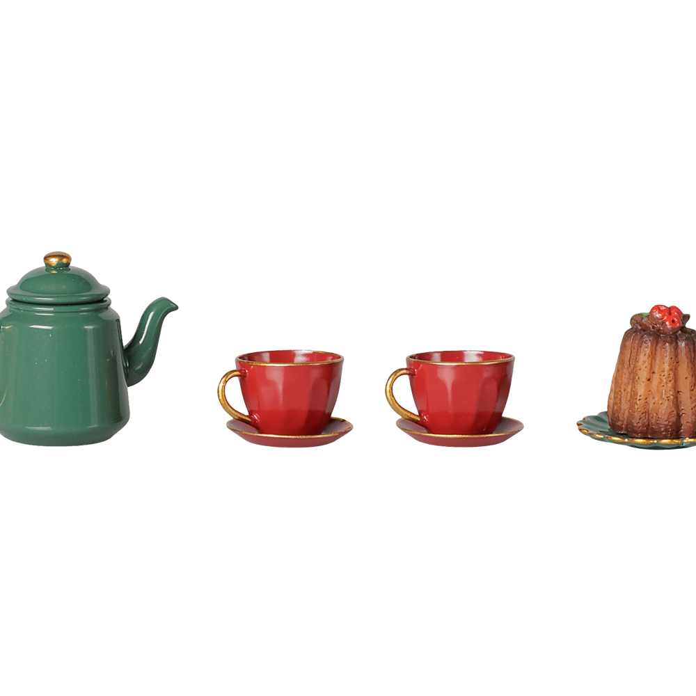 A green metal teapot, two red teacups and saucers, and a miniature cake on a decorative plate, displayed on a transparent background.