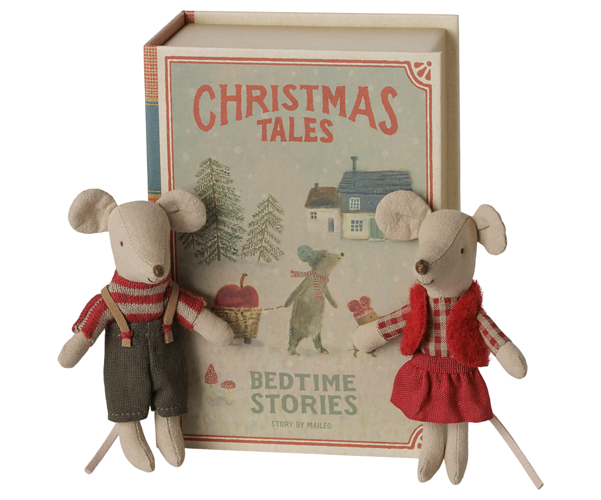 A children's book titled 'Christmas Tales: Bedtime Stories' displayed upright with two small plush mouse toys in front on a plain white background.