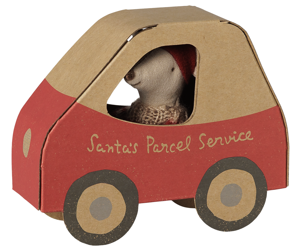 A Maileg Christmas Little Sister mouse wearing a festive red and white patterned knit sweater and a red pixy hat, peeking out from the window of a miniature cardboard car-shaped box labeled "Santa's Parcel Service" with red detailing and illustrated wheels.