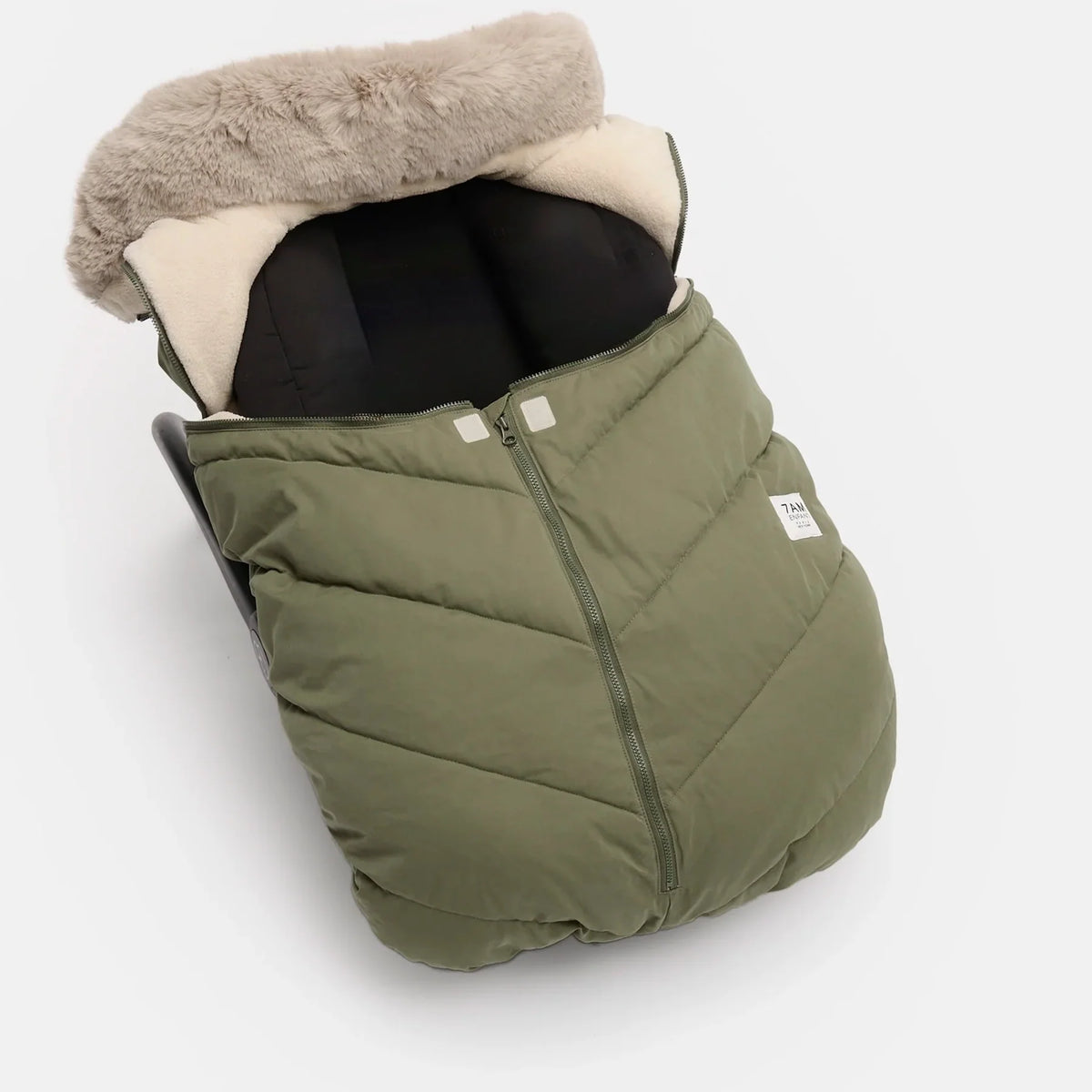 An olive green puffer baby footmuff with a beige faux-fur trim and cream interior lining, shown on a light gray background.