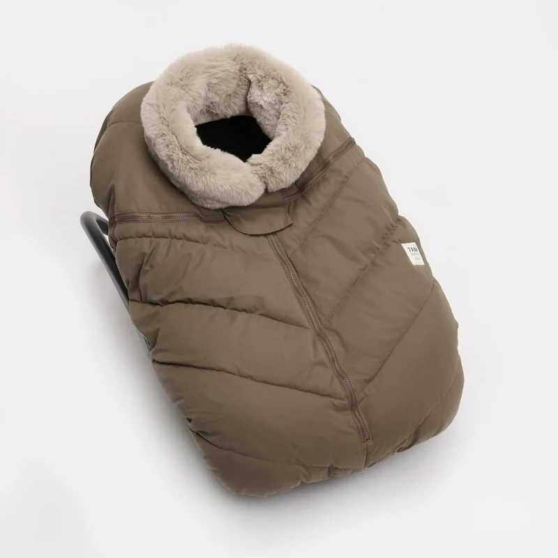 Moss brown Helsinki Car Seat Cocoon by 7AM Enfant showing the front view with a plush faux-fur collar and central zipper.