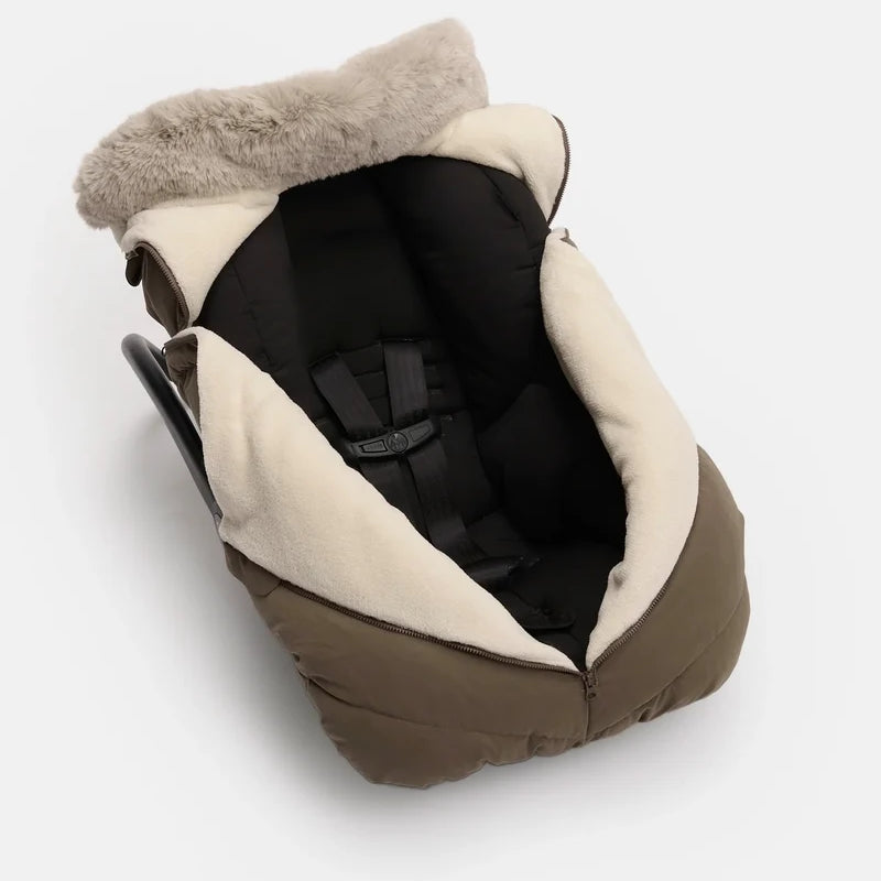 Moss brown Helsinki Car Seat Cocoon by 7AM Enfant shown installed on an infant car seat, featuring a plush faux-fur collar and harness compatibility.