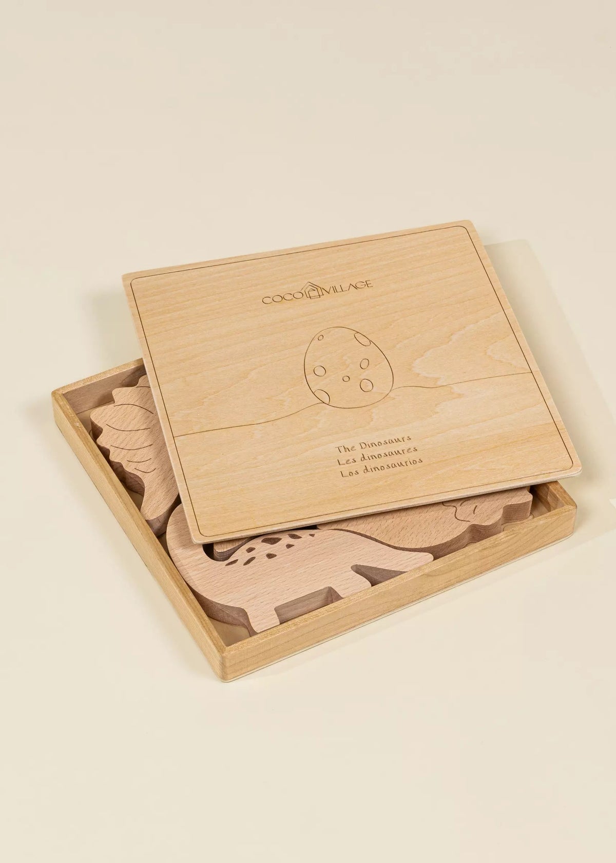 Wooden toy set with animals in a box on a beige background
