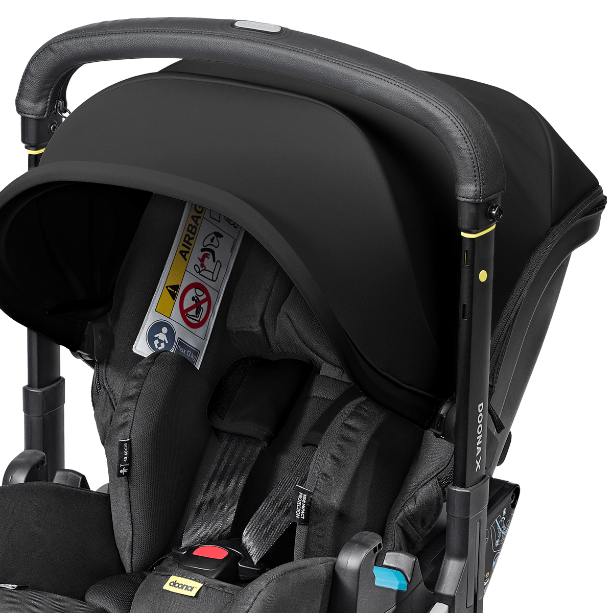 Black car seat with stroller attachment on a black background