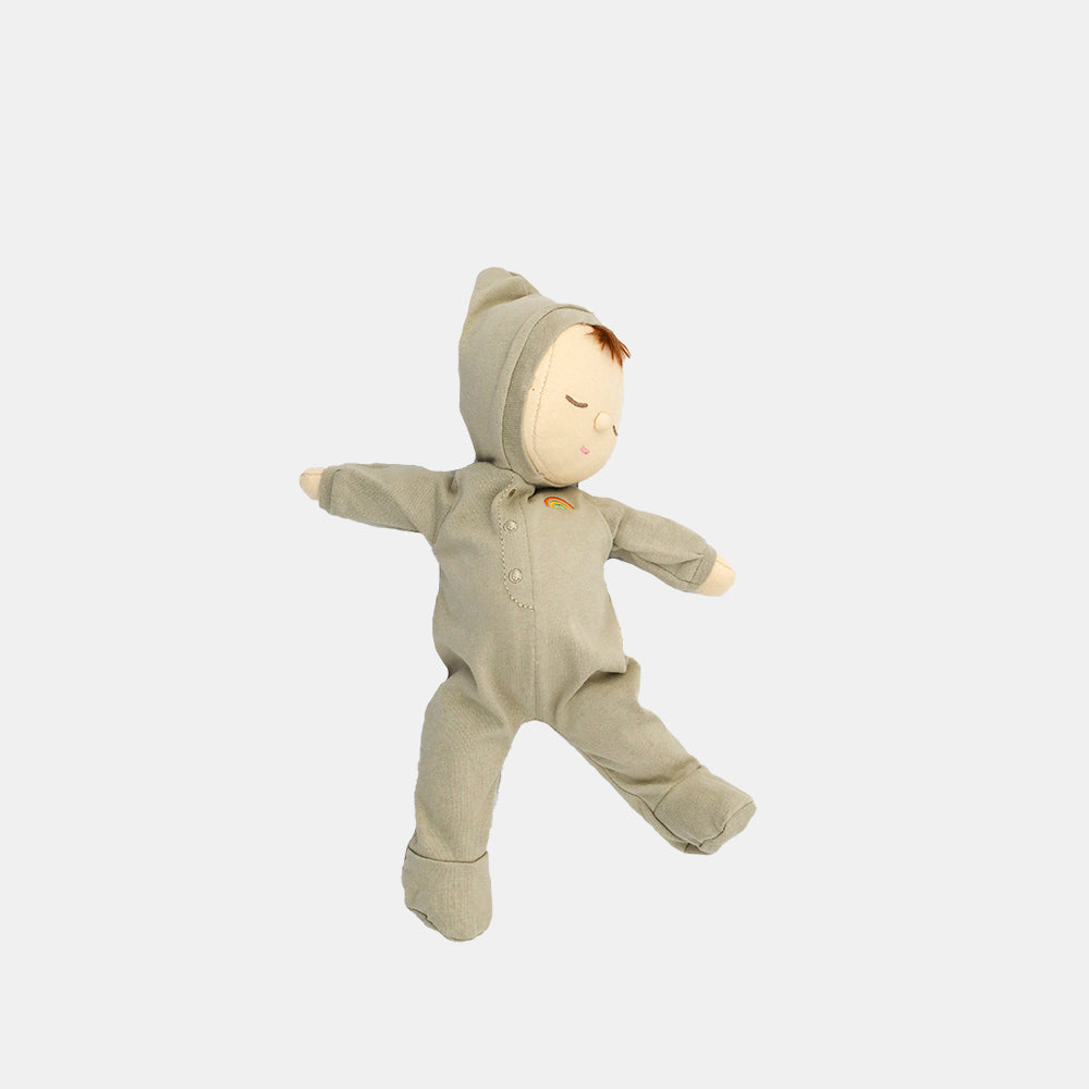 Toy doll in a green onesie on a white background