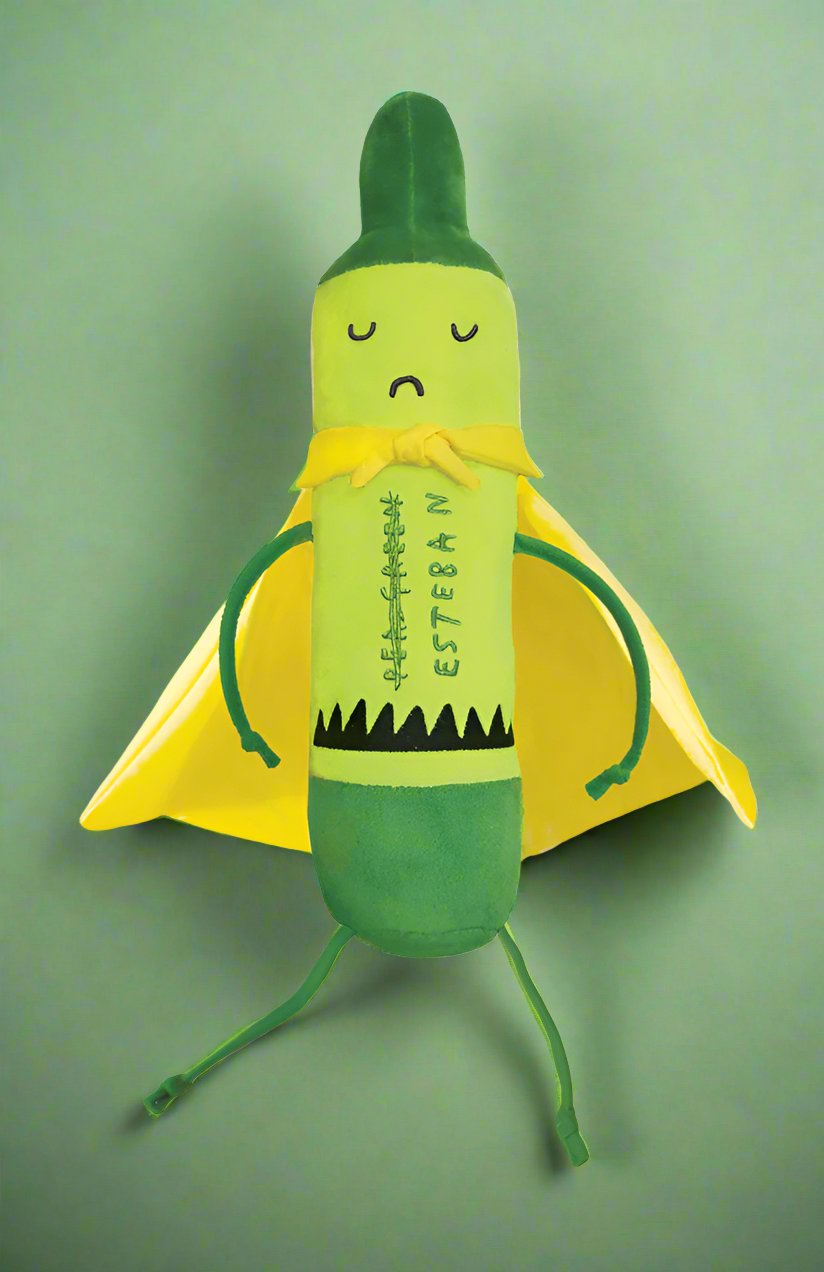 A green and yellow plush toy shaped like a banana wearing a yellow cape, standing against a solid green background.