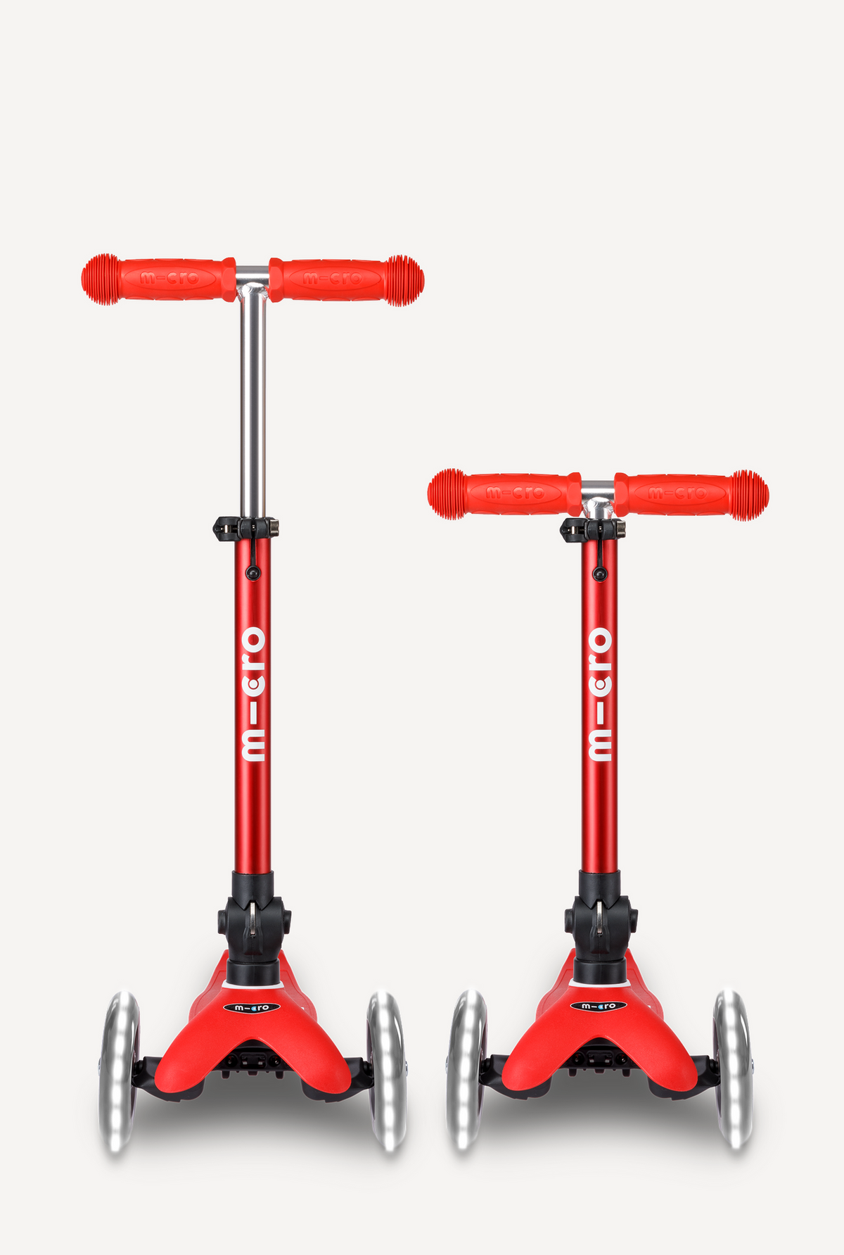 Two red scooter toys with M-Wave branding on a white background