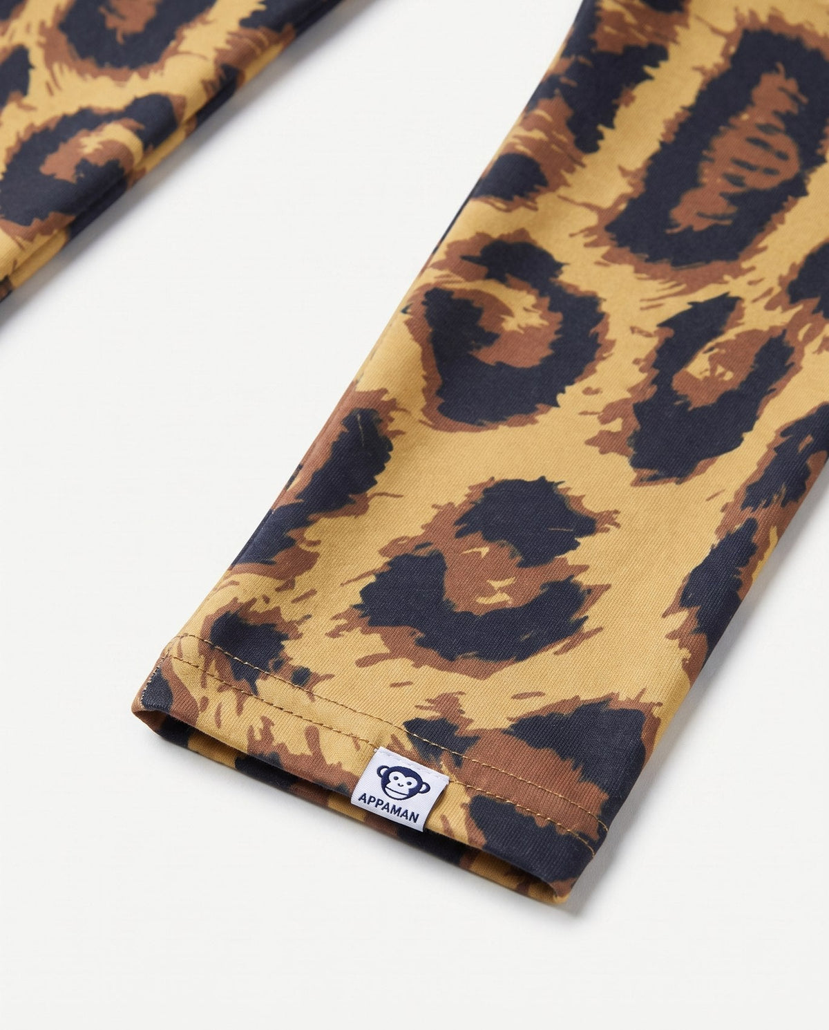 Leopard print fabric with a visible brand label on a white background