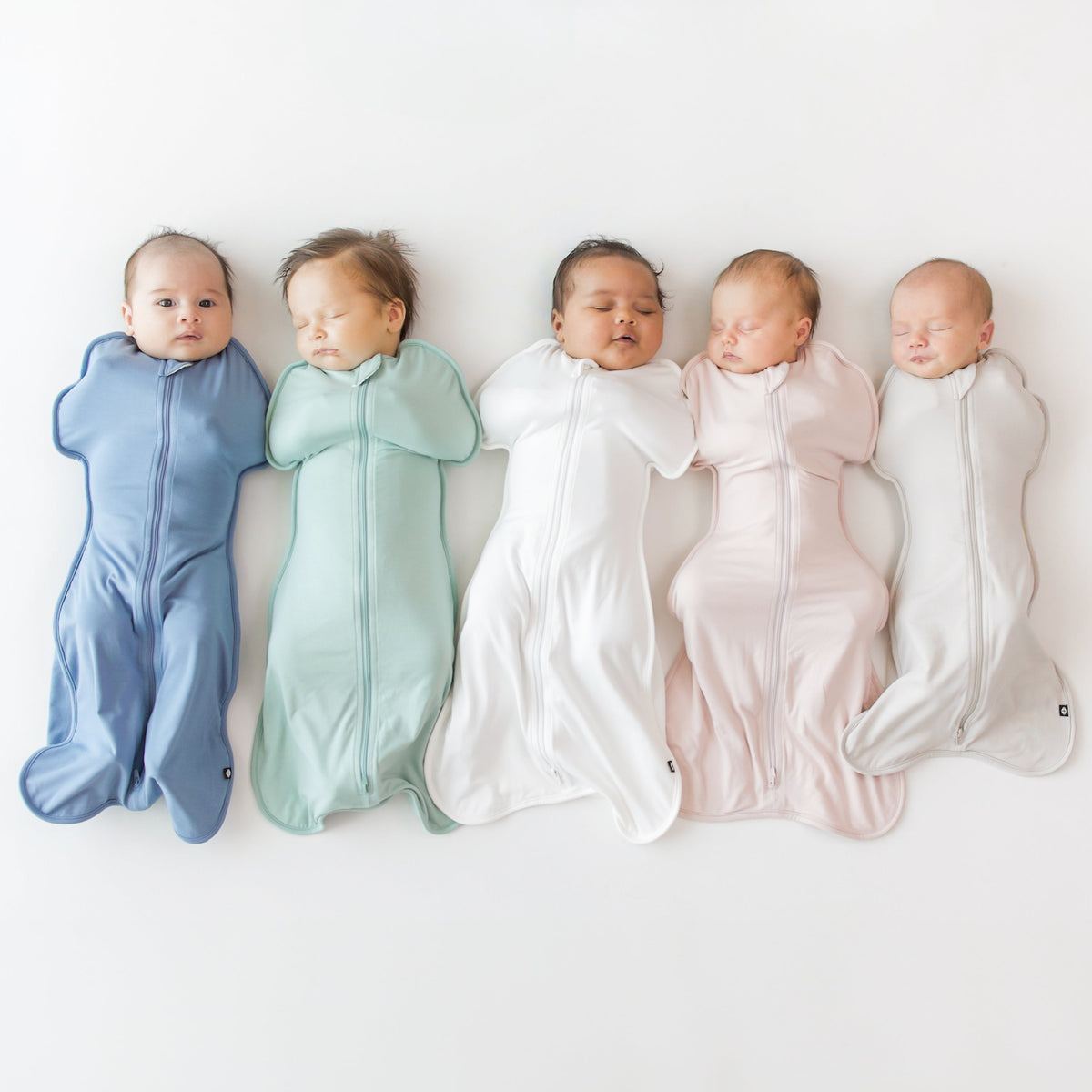 Five babies wrapped in colorful swaddles on a white background