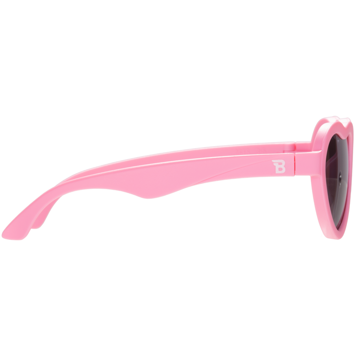Pink sunglasses with a brand logo on a white background